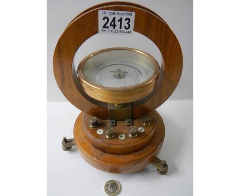 A horizontal tangent laboratory galvanometer by Philip Harris &amp; Co., Birmingham. Brass cased instrument mounted in a maho