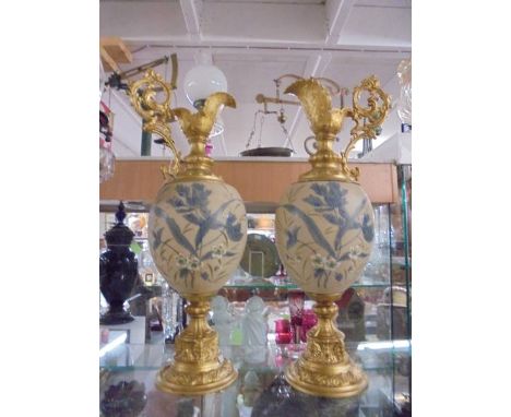 A pair of gilded and ceramic hand painted ewers, COLLECT ONLY.
