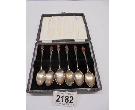 A cased set of Art Deco sterling silver enamelled teaspoons by W H Haseler, Birmingham 1934, 40 grams.