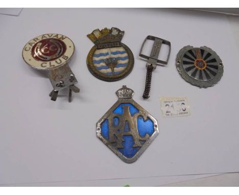 A Rotary Club, Caravan Club and RAC car badges with a Pinin Forina car mascot and an Aluminium Bulwark plaque.