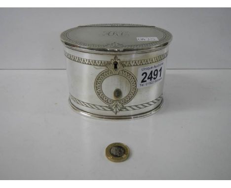 A monogrammed silver plate tea caddy.