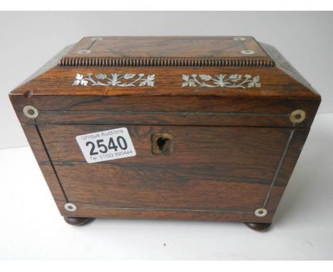 A Victorian rosewood tea caddy inlaid with mother of pearl.