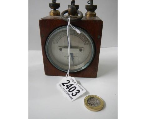 A differential galvanometer mounted in a wooden case for portability, made by Edison &amp; Swan, 1915.