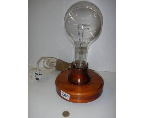 A large laboratory light bulb mounted on a wooden base in working order, COLLECT ONLY.Worked when tested