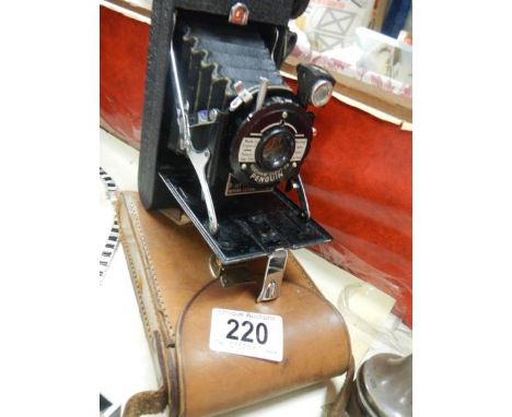 A vintage Penguin folding camera in case.