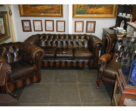 A deep buttoned three peice suite comprising Chesterfield sofa, Chesterfield chair and wing arm chair, COLLECT ONLY.