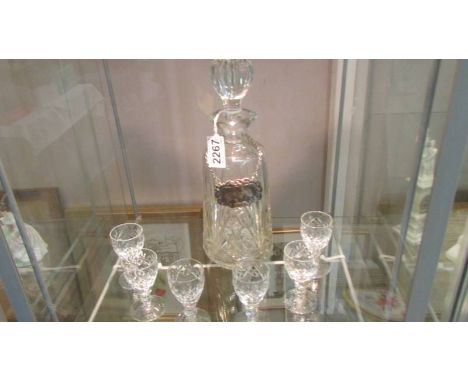 A cut glass decanter and six glasses.