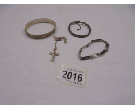 A silver bangle, a silver child's bangle, a silver bracelet and a silver cross on chain.