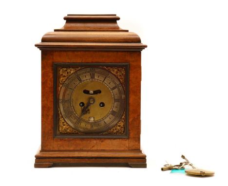 A mahogany and walnut mantel clock,early 20th century, the metal dial with Roman numerals, to a walnut veneered and glazed do