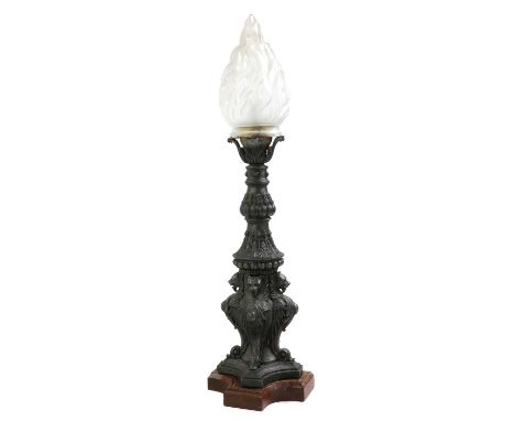 A patinated metal floor lamp with flame shade,38cm wide38cm deep137cm highCondition ReportPitted throughout. Base detached bu