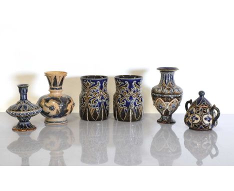 A pair of Doulton Lambeth stoneware vases, three vases, and a sucrier and cover,various artists, each with incised floral pan