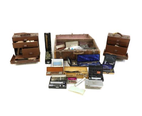 Two leather travelling medical chests,early 20th century, each interior fitted with three drawers containing various medical 