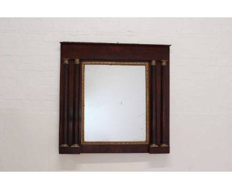A French Empire mahogany overmantel mirror,first half of the 19th century, the rectangular mirror plate with a gilt gesso fol