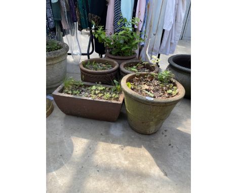 FOUR VARIOUS DECORATIVE TERRACOTTA PLANT POTS AND A TROUGH