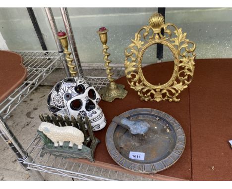 AN ASSORTMENT OF ITEMS TO INCLUDE A BRASS PICTURE FRAME, A PAIR OF BRASS CANDLE STICKS AND A CERAMIC SKULL ETC