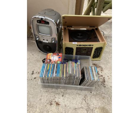 A PORTABLE RECORD PLAYER, A JUKEBOX MACHINE AND VARIOUS CDS