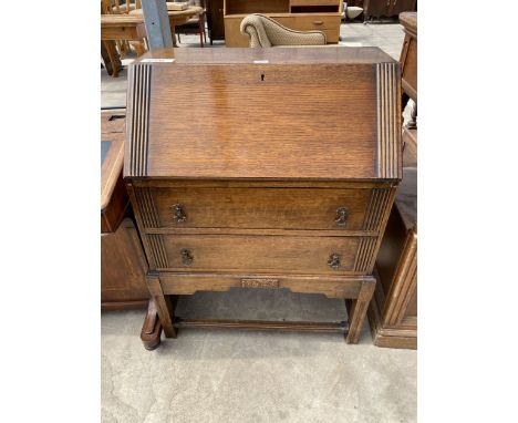 A MID 20TH CENTURY OAK BUREAU ON OPEN BASE, 29" WIDE