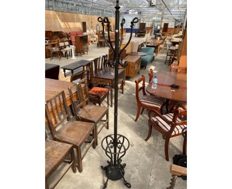 A BLACK TUBULAR SHAPED COAT/STICK STAND