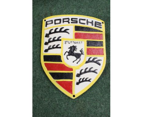 A CAST PORSCHE SIGN, 21CM X 28CM