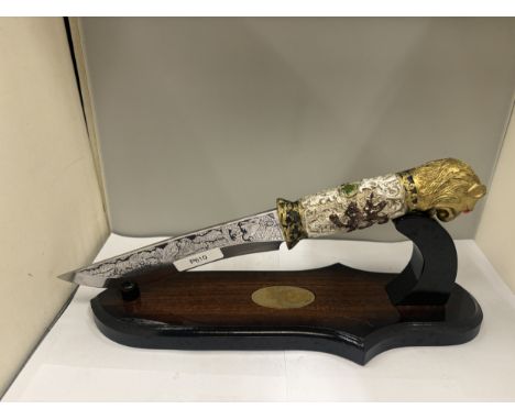 A FANTASY DAGGER WITH PANTHER HEAD HANDLE PLUS A KNIFE STAND
