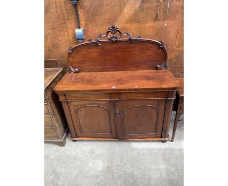 A VICTORIAN MAHOGANY CHIFFONIER WITH RAISED BACK HAVING FOLIATE DECORATION ENCLOSING TWO DRAWERS AND TWO CUPBOARDS, 54" WIDE