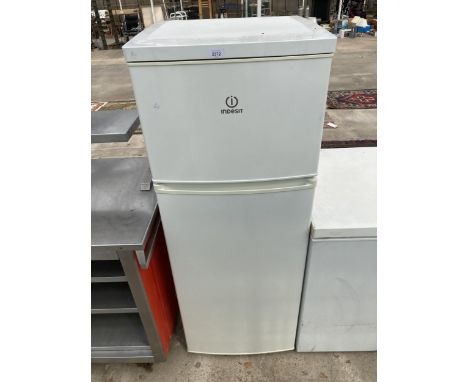 A WHITE INDESIT UPRIGHT FRIDGE FREEZER