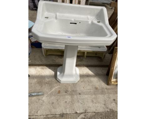 A WHITE CERAMIC PEDESTAL SINK UNIT