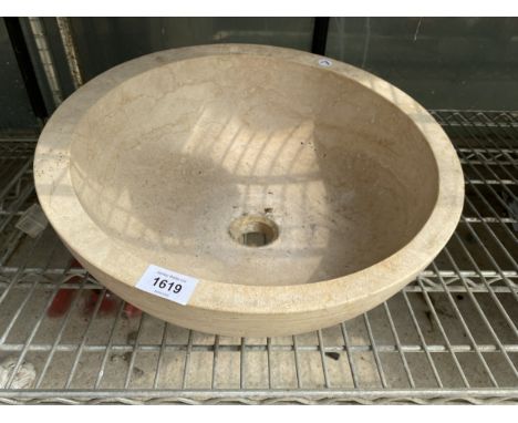 A CIRCULAR MARBLE WASH BASIN