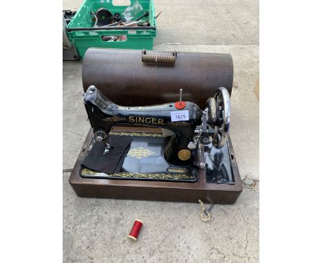 A VINTAGE SINGER SEWING MACHINE WITH WOODEN CARRY CASE
