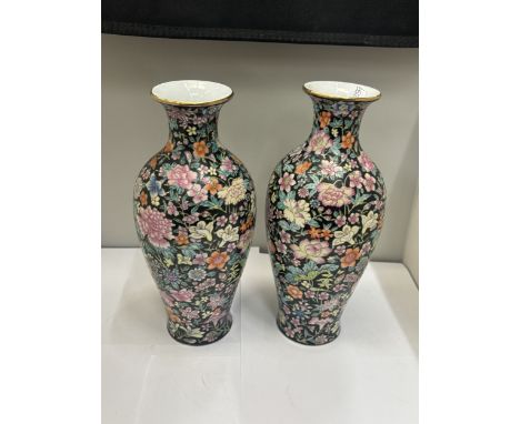 A PAIR OF CHINESE FAMILLE ROSE VASES WITH BLUE SEAL MARK TO THE BASE DECORATED WITH COLOURFUL BLOSSOMS AGAINST A BLACK BACKGR