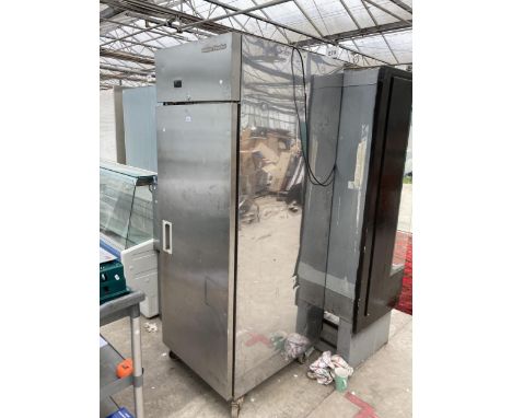 A TALL INDUSTRIAL STAINLESS SNOWFLAKE FRIDGE