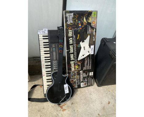 TWO GUITAR HERO GUITARS AND A SMALL KEYBOARD