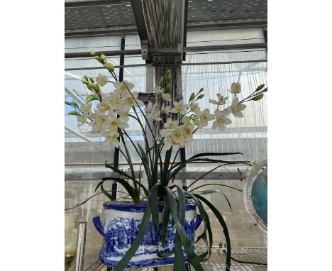 A LARGE BLUE AND WHITE CERAMIC TROUGH WITH ARTIFICIAL ORCHIDS