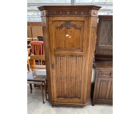 AN EARLY 20TH CENTURY OAK HALL WARDROBE WITH LINEN FOLD AND FOLIATE DECORATION 38" WIDE
