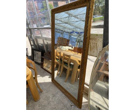 A LARGE GILT FRAMED BEVEL EDGE WALL MIRROR, 72" X 42"