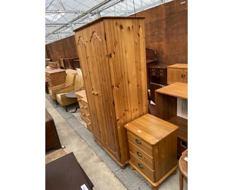 A PINE TWO DOOR WARDROBE 34" WIDE AND A PINE THREE DRAWER BEDSIDE CHEST WITH SCOOP HANDLES