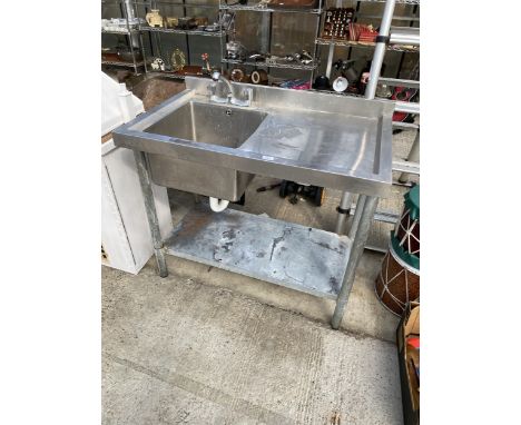 AN INDUSTRIAL STAINLESS STEEL SINK UNIT WITH LOWER SHELF