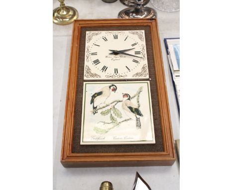 A WALL CLOCK WITH A CERAMIC TILE FACE AND CERAMIC TILE DECORATION OF GOLDFINCHES