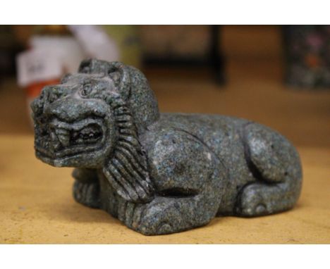 A STONE CARVING OF A FOO DOG