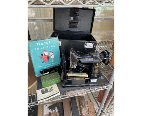 A SINGER 222K ELECTRIC SEWING MACHINE WITH CARRY CASE, FOOT PEDAL, MAT, BOOK AND FURTHER ACCESSORIES