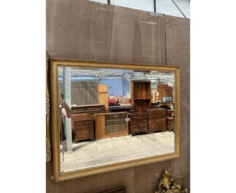 A GILT FRAMED WALL MIRROR WITH BEVEL EDGE, 43" X 33"
