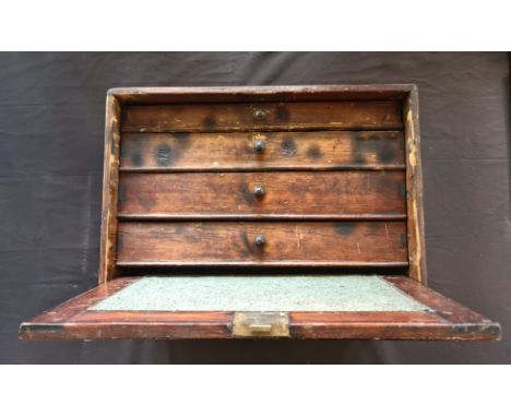 A four drawer toolbox chest with tools.