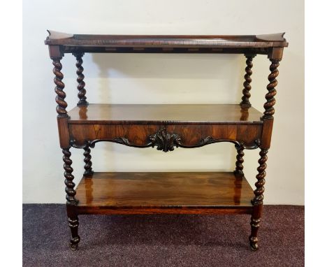 A Victorian rosewood dumbwaiter fitted with two drawers barely twist columns and three shelves.