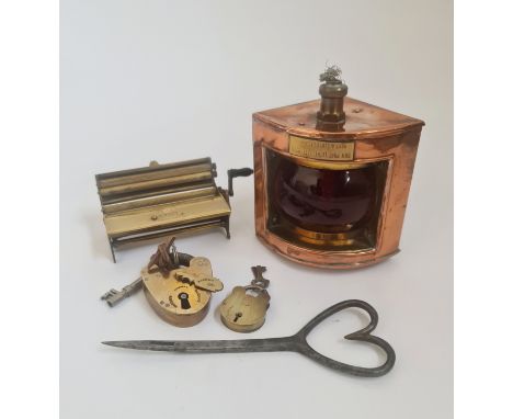 Two brass padlocks with key, Best &amp; Lloyd port light, and Evans &amp; Co cigarette rolling machine.