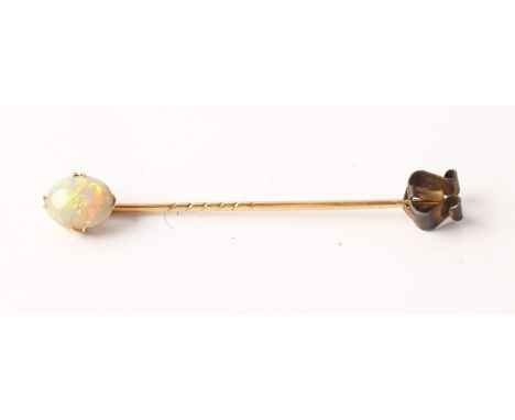 An oval opal cabochon stick pin, opal measures approx. 10x8mm, unmarked yellow metal.