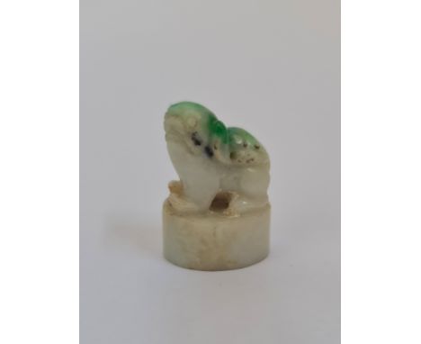 A carved Chinese pale green to dark jade foo dog seal pendant. 3cm.