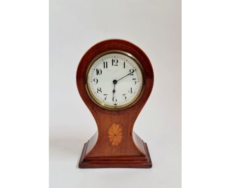 A mahogany balloon shaped mantle clock with inlaid border. 22 1/2 cm.