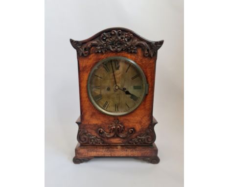 A bracket clock with brass double fusee clock movement with a later oak case and brass face with Roman numerals. Approx 50 cm