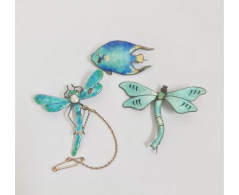Two enamel dragonfly brooches and an enamel fish brooch.