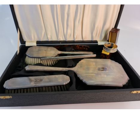 A hallmarked silver dressing table set, comprising of a hand mirror, hair brush, comb, clothes brush (in box), with an initia